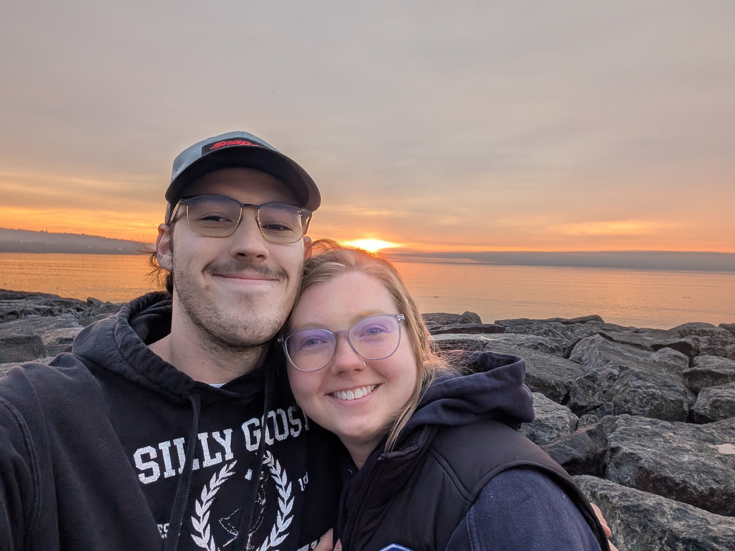 Jenny and Tanner at sunset on a rocky shore